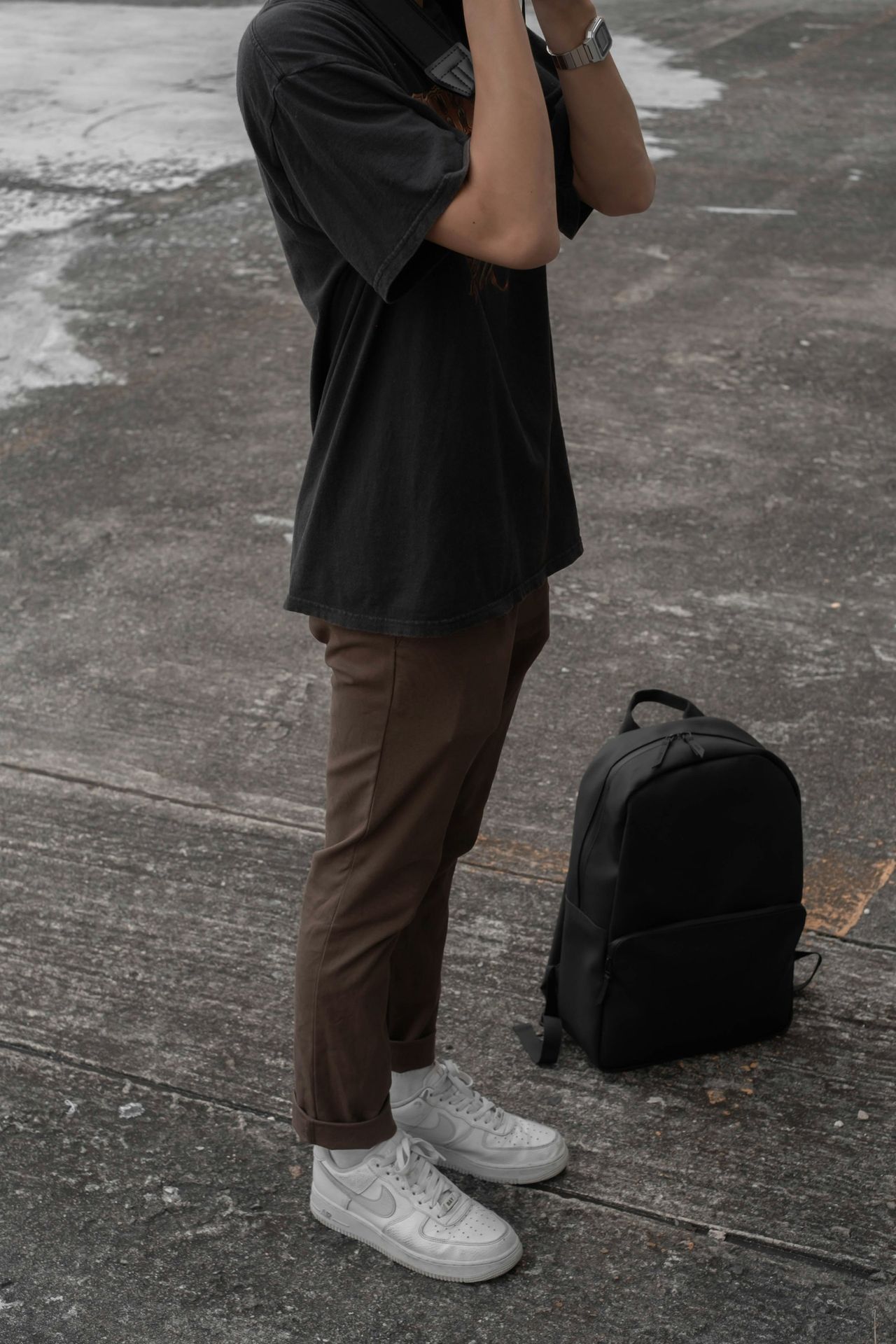 a person walking down the street talking on a cell phone